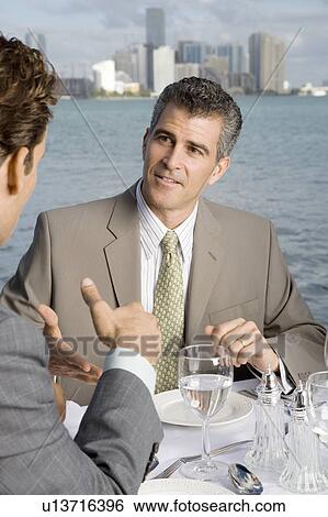 Stock Photograph - Two businessman having lunch. Fotosearch