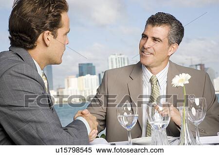 Stock Photography - Two businessman having lunch. Fotosearch