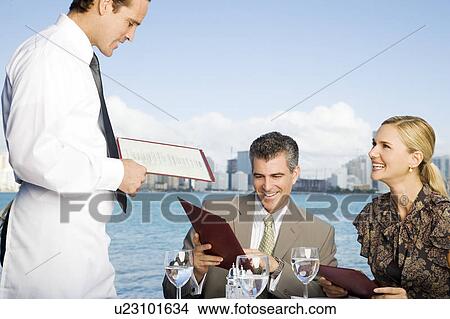 Picture - Two colleagues having lunch. Fotosearch