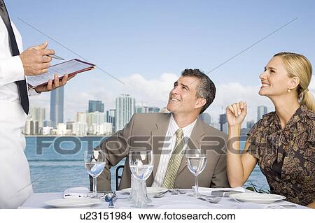Picture - Two colleagues having lunch. Fotosearch