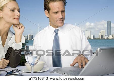Stock Image - Two colleagues having lunch. Fotosearch