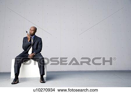 A businessman using a mobile phone View Large Photo Image Picture - A businessman using a mobile phone. Fotosearch