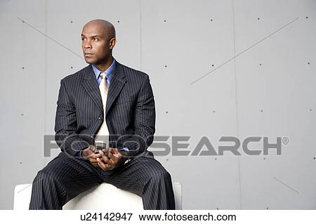 A businessman using a mobile phone View Large Photo Image Stock Photo - A businessman using a mobile phone. Fotosearch