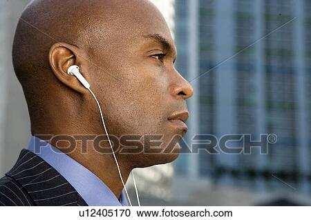 A businessman wearing headphones View Large Photo Image Stock Image - A businessman wearing headphones. Fotosearch