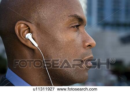 A businessman wearing headphones View Large Photo Image Stock Photo - A businessman wearing headphones. Fotosearch