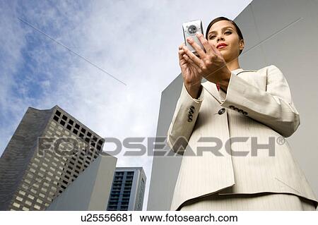 A businesswoman reading a text message View Large Photo Image Stock Image - A businesswoman reading a text message. Fotosearch