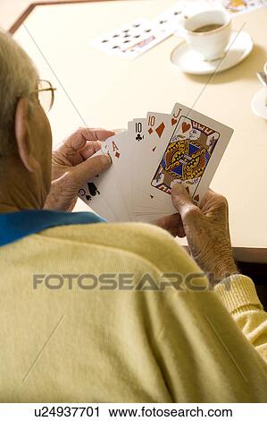 An elderly man playing cards View Large Photo Image Stock Image - An elderly man playing cards. Fotosearch