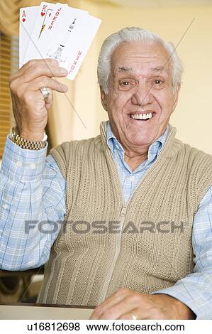 An elderly man playing cards View Large Photo Image Stock Photo - An elderly man playing cards. Fotosearch