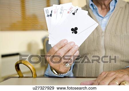 An elderly man playing cards View Large Photo Image Stock Photo - An elderly man playing cards. Fotosearch