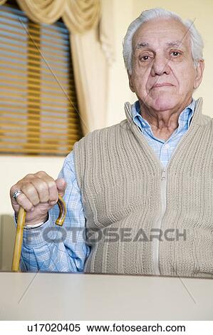 Stock Photography - An elderly man sitting in a chair. Fotosearch
