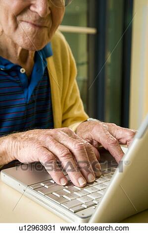 An elderly man using a laptop View Large Photo Image Stock Image - An elderly man using a laptop. Fotosearch