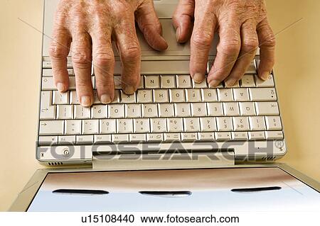 An elderly man using a laptop View Large Photo Image Stock Image - An elderly man using a laptop. Fotosearch