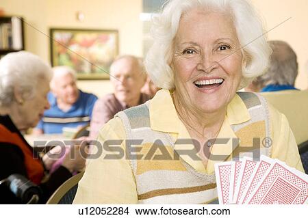 An elderly woman playing cards View Large Photo Image Picture - An elderly woman playing cards. Fotosearch
