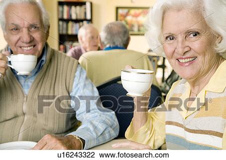 Stock Image - Four residents in a retirement home. Fotosearch