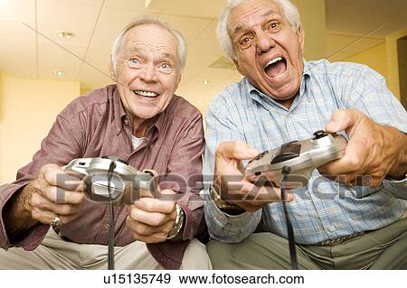 Stock Photo - Two elderly men playing a video game. Fotosearch