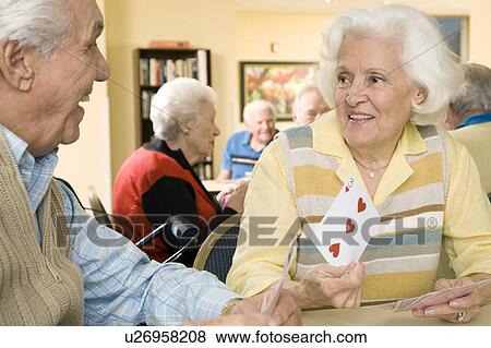 Two residents in a retirement home playing cards View Large Photo Image Stock Photo - Two residents in a retirement home playing cards. Fotosearch