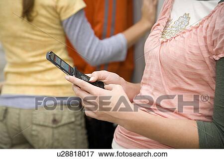 Stock Photo - A teenage girl using a mobile phone. Fotosearch