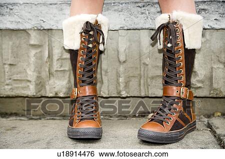 Stock Photograph - A teenager wearing boots. Fotosearch