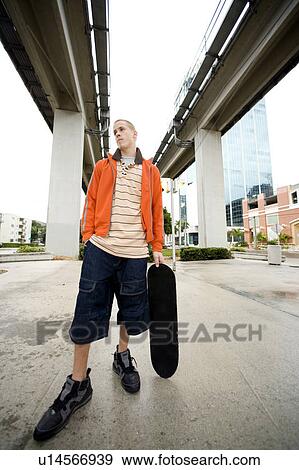 Stock Photo - A teenager with a skateboard. Fotosearch