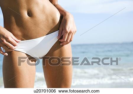 A young woman on the beach View Large Photo Image Stock Photograph - A young woman on the beach. Fotosearch