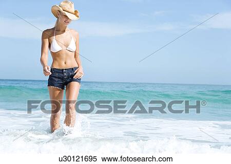 A young woman paddling in the sea View Large Photo Image Stock Photography - A young woman paddling in the sea. Fotosearch