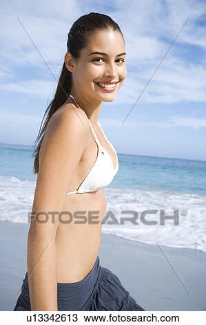 A young woman walking on the beach View Large Photo Image Stock Image - A young woman walking on the beach. Fotosearch