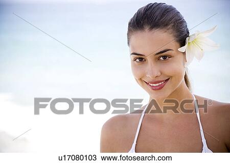Portrait young Hispanic woman with flower in hair View Large Photo Image Stock Image - Portrait young Hispanic woman with flower in hair. Fotosearch