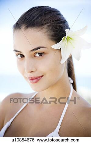 Portrait young Hispanic woman with flower in hair View Large Photo Image Stock Photograph - Portrait young Hispanic woman with flower in hair. Fotosearch