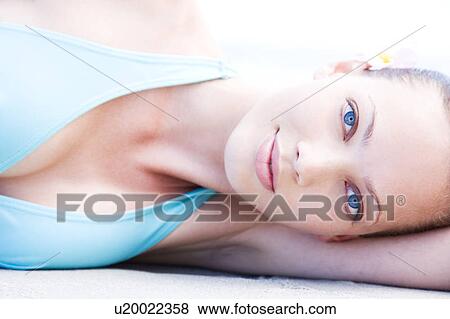 Portrait young woman lying on side View Large Photo Image Stock Photo - Portrait young woman lying on side. Fotosearch