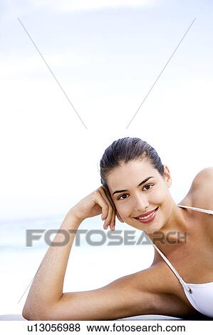 Portrait young woman lying on the beach View Large Photo Image Stock Photo - Portrait young woman lying on the beach. Fotosearch