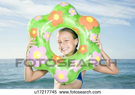 A young girl's face seen through a rubber ring View Large Photo Image Stock Photography - A young girl's face seen through a rubber ring. Fotosearch