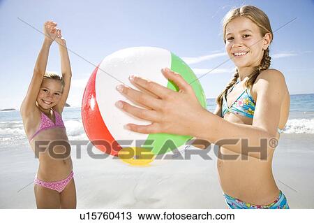 Two young girls playing on the beach View Large Photo Image Stock Image - Two young girls playing on the beach. Fotosearch
