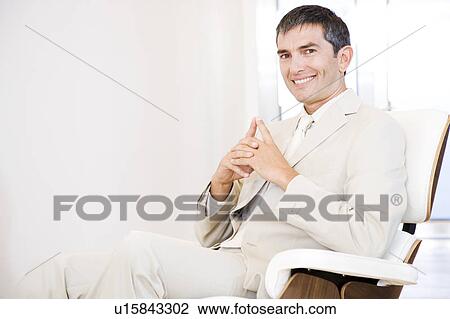 A businessman looking happy and relaxing in a chair View Large Photo Image Stock Image - A businessman looking happy and relaxing in a chair. Fotosearch