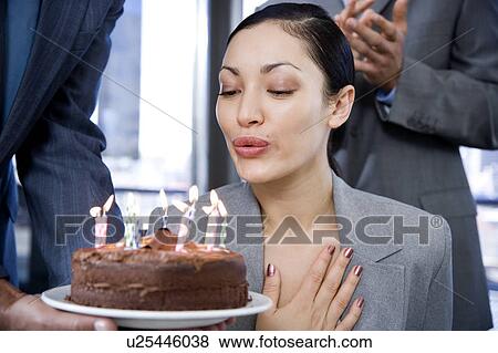 Stock Photo - Business colleagues celebrating a businesswoman's birthday. Fotosearch