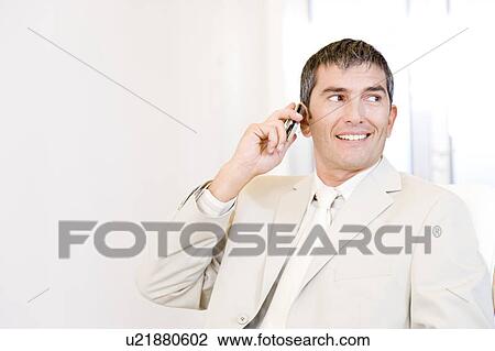 Stock Image - Businessman using a mobile telephone. Fotosearch