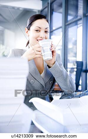 Businesswoman enjoying a coffee or tea break View Large Photo Image Stock Photo - Businesswoman enjoying a coffee or tea break. Fotosearch