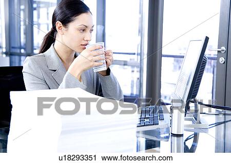 Businesswoman having a tea or coffee break View Large Photo Image Stock Image - Businesswoman having a tea or coffee break. Fotosearch