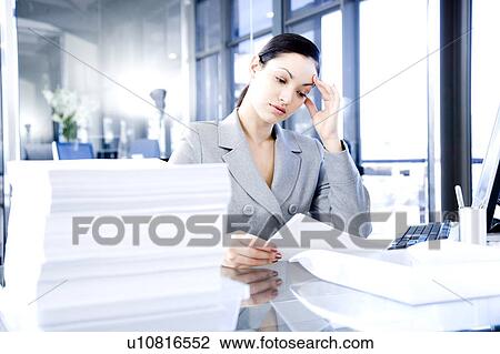 Businesswoman looking stressed with her paperwork View Large Photo Image Stock Image - Businesswoman looking stressed with her paperwork . Fotosearch