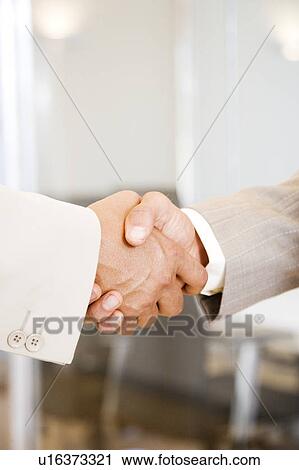 Close up of a two businessmen shaking hands View Large Photo Image Stock Image - Close up of a two businessmen shaking hands. Fotosearch