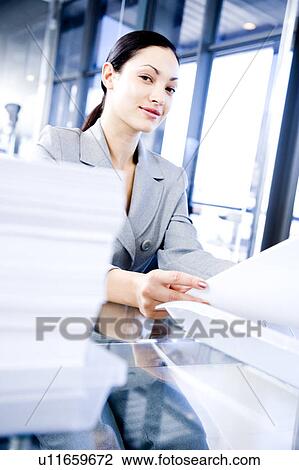 Smiling businesswoman with paperwork View Large Photo Image Stock Image - Smiling businesswoman with paperwork. Fotosearch