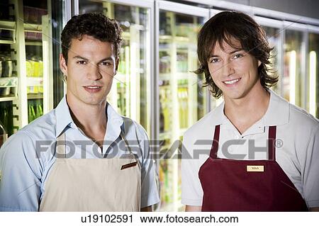Stock Image - Portrait of shop assistants in a supermarket. Fotosearch