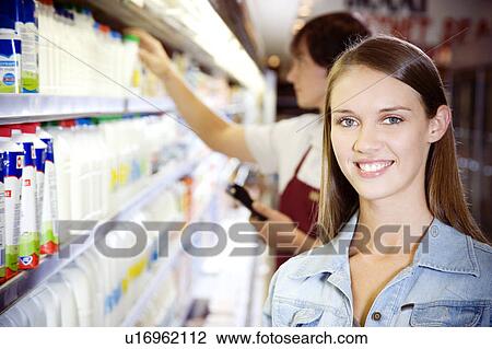 Shop assistant and a customer View Large Photo Image Stock Image - Shop assistant and a customer. Fotosearch