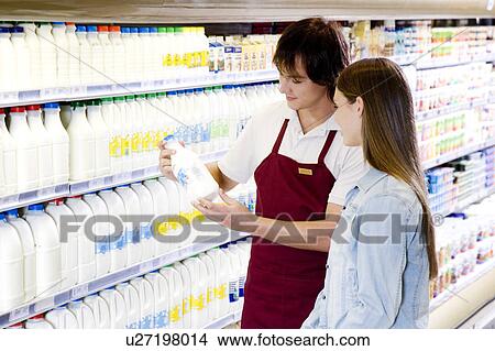 Picture - Shop assistant helping a customer. Fotosearch