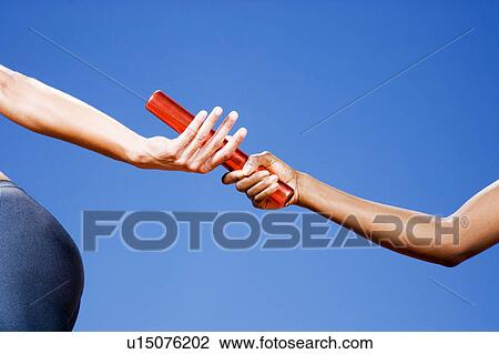Baton passing between relay runners View Large Photo Image Stock Image - Baton passing between relay runners. Fotosearch