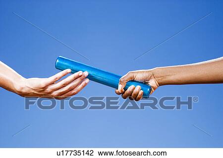Baton passing between relay runners View Large Photo Image Stock Image - Baton passing between relay runners. Fotosearch