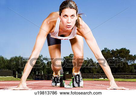 Female athlete in the starting blocks View Large Photo Image Stock Photograph - Female athlete in the starting blocks. Fotosearch
