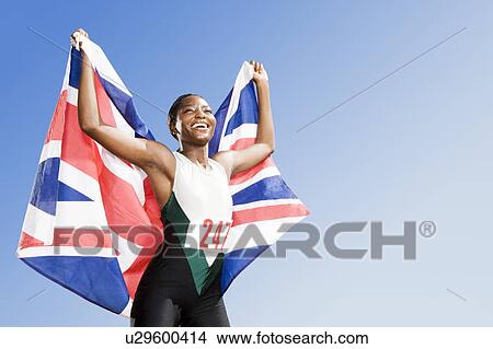 Picture - Portrait of a female athlete celebrating her win. Fotosearch