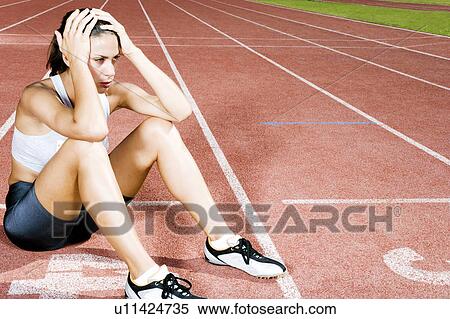 Stock Photography - Portrait of a female athlete resting. Fotosearch