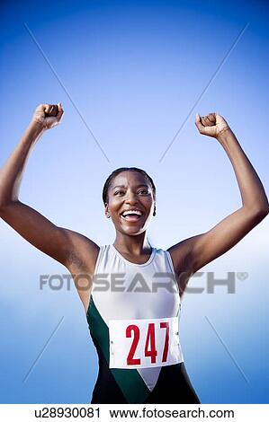 Portrait of a female athlete with her arms in the air View Large Photo Image Stock Image - Portrait of a female athlete with her arms in the air. Fotosearch