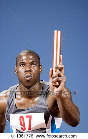 Portrait of an athlete with a baton View Large Photo Image Stock Photograph - Portrait of an athlete with a baton. Fotosearch
